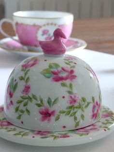 a tea pot and saucer sitting on a table