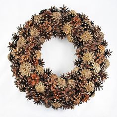 a wreath made out of pine cones on a white background