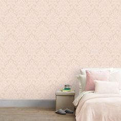 a bedroom scene with focus on the bed and wallpapers that are soft pink