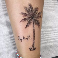 a small palm tree tattoo on the ankle