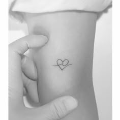 Fine line wave and heart tattoo placed on the inner Heart Beach Tattoo, Wave Heartbeat Tattoo, Women’s Fine Line Tattoos, Heart With Heartbeat Tattoo, Sun And Heart Tattoo, Fine Line Family Tattoo Ideas, Fine Line Beach Tattoo Ideas, Fine Line Friendship Tattoo, Fine Line Couple Tattoo