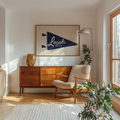 a living room with a large painting on the wall next to a chair and potted plant