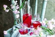 a table topped with bottles and glasses filled with liquid