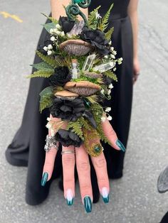 a woman's hand with green and black flowers on it