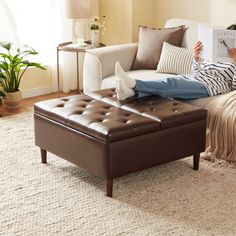 a person laying on a couch reading a book