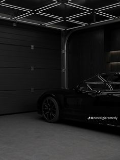 a black sports car parked in a garage with its lights on and the door open