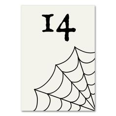 a card with the number four on it and a spider web in front of it