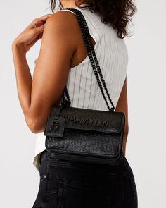 The structured COAL Bag crossbody bag is designed with expandable side gussets so you'll have plenty of room for all your essentials. Structured crossbody bag Flap closure at front All-over embossed logo pattern Removable logo tag Chain strap for crossbody and over-the-shoulder wear Crossbody strap drop: 24 inches 5.5in H x 8in W x 3.25in D Synthetic materials Duster bag included Imported Steve Madden Bags Handbags, Steve Madden Bags, Crossbody Bag Women, Synthetic Materials, Logo Tag, Logo Pattern, Women's Handbags, Black Logo, Embossed Logo