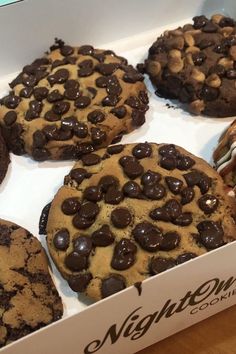 a box filled with chocolate chip cookies on top of a wooden table