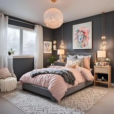 a bedroom with gray walls and pink comforter on the bed, two lamps hanging from the ceiling