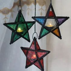 three stained glass stars hanging from chains