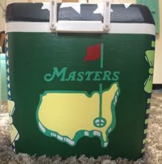 a green and yellow cooler with the words masters on it