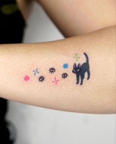 a black cat with stars on it's arm is seen in this tattoo design