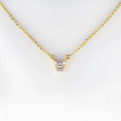 This beautiful trio baguette necklace features a classic design made of three glittering baguettes surrounded by a shiny gold plated chain. It's the perfect accessory for any occasion, sure to add a sparkle to your look. Dainty Gold Baguette Cut Necklace, Gold Baguette Diamond Necklace, Diamond Wrap Ring, Baguette Studs, Baguette Necklace, Stacker Rings, Multi Sapphire, Simple Bracelets, Initial Ring