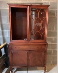 an antique china cabinet with glass doors