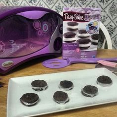 an electric cookie maker and cookies on a table