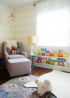 a child's room with a teddy bear on the floor