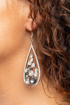 An oversized collection of smoky and glittery white rhinestones collect inside a shimmery silver teardrop. One side of the frame is encrusted in dainty white rhinestones, adding an elegant edge to the glamorous lure. Earring attaches to a standard fishhook fitting. Sold as one pair of earrings. This piece was featured as part of our Fall Training during Unwritten. Fish Hook Earrings, Paparazzi Accessories, White Rhinestone, Earring Sale, Fish Hook, Vintage Accessories, Twinkle Twinkle, Amazing Jewelry, Jewelry Shop