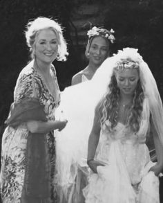 three women in wedding dresses standing next to each other