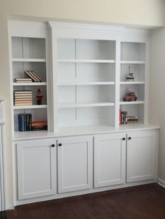 white bookcases with doors and drawers in a room