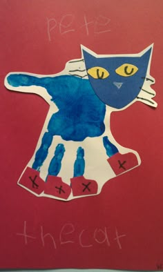 a drawing of a blue cat on a red background