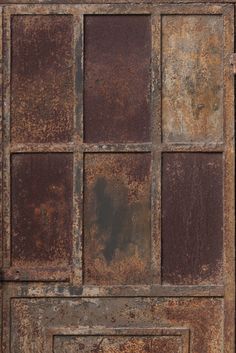 an old rusty metal door with squares on it