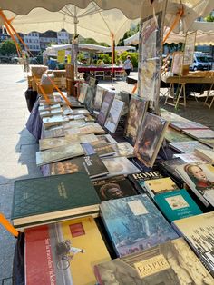 many books are on display under an umbrella