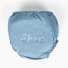 a blue cloth diaper with the word shep embroidered on it's side