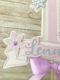 a cake topper with the number one decorated in frosting and snowflakes