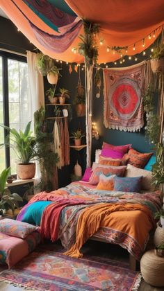 a bed with lots of pillows and blankets on top of it in a room filled with potted plants