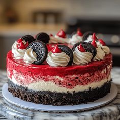 a red, white and black cake with oreo cookies on top