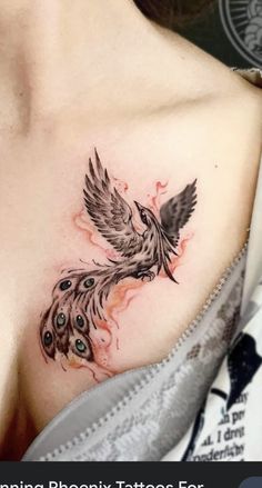 a woman with a tattoo on her chest has a bird and feathers painted on it