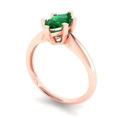 a ring with a green stone in the center