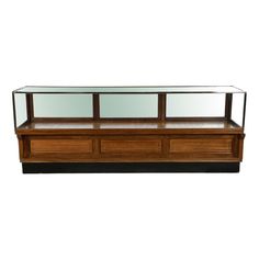 a wooden and glass display case with two shelves on one side, the top shelf is empty