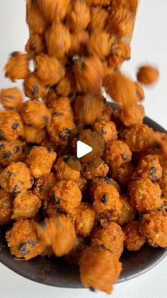 a plate full of fried food on top of a white tablecloth with a video player in the background