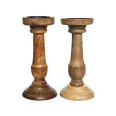 two wooden candlesticks sitting next to each other