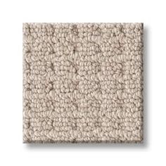 a beige carpet with small squares on the top and bottom, in varying shades of cream