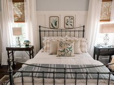 a bed with white sheets and pillows in a bedroom