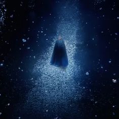 a person standing in the middle of a dark room with stars all around them and an umbrella hanging from the ceiling