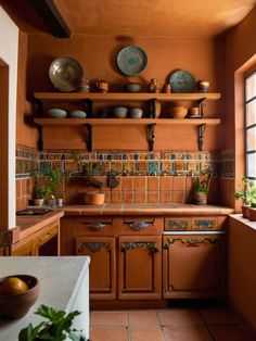 a kitchen filled with lots of wooden cabinets and counter top space next to a window