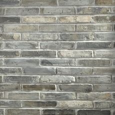 a brick wall that is made out of grey bricks