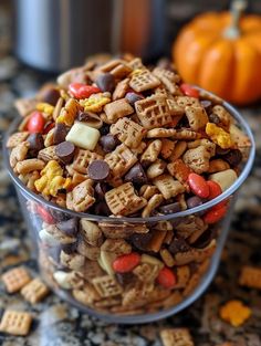 a glass bowl filled with halloween snack mix