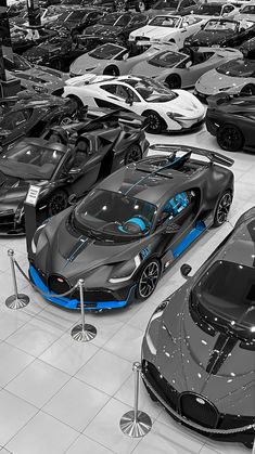 a bunch of cars are parked in a showroom