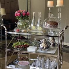 a silver serving cart filled with lots of food