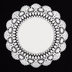 a white doily on a black background with an empty circle cut out in the middle