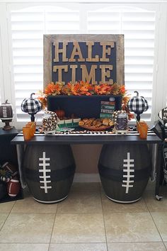 a football themed party with black and white decorations, pumpkins and an old wooden sign