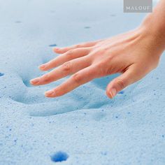 a person's hand reaching for something in the sand