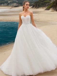 a woman in a wedding dress on the beach