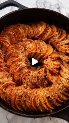 an iron skillet filled with cooked sweet potatoes