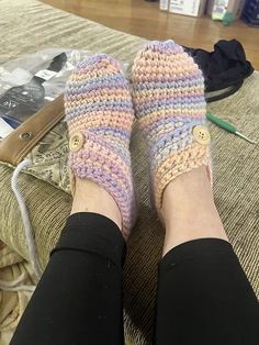 A pair of modern crochet slippers worn by a woman.